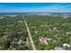 Aerial view of the neighborhood and home surrounded by mature trees at 2605 Desoto Rd, Sarasota, FL 34234