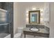 Bathroom with granite counter, shower with glass door and accent lighting at 2605 Desoto Rd, Sarasota, FL 34234