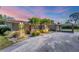 Charming single-story home featuring a red tile roof, carport, mature landscaping, and brick accents at 2605 Desoto Rd, Sarasota, FL 34234