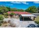 Sprawling home with a red tiled roof, carport, lush greenery, and spacious driveway at 2605 Desoto Rd, Sarasota, FL 34234