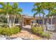 Charming home featuring a brick pathway, tiled roof, well-manicured landscaping, and mature trees at 2605 Desoto Rd, Sarasota, FL 34234