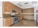 Well-maintained kitchen featuring wood cabinets and stainless steel appliances at 2605 Desoto Rd, Sarasota, FL 34234