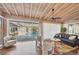 Bright sunroom with modern furniture, access to the pool, and a view of lush greenery at 2605 Desoto Rd, Sarasota, FL 34234