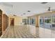 Bright, spacious living room with tiled floors, and large sliding glass doors that lead to the pool at 2605 Desoto Rd, Sarasota, FL 34234