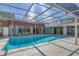 Stunning backyard pool with a screened enclosure, perfect for swimming and outdoor fun with Gathering and friends at 2605 Desoto Rd, Sarasota, FL 34234