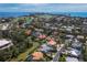 Expansive aerial view featuring homes, pools, waterways, golf course, and ocean coastline at 3260 Bayou Rd, Longboat Key, FL 34228
