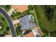 Aerial view of home with a gray tile roof and backyard pool overlooking the canal at 3260 Bayou Rd, Longboat Key, FL 34228
