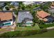 Aerial view of home with pool and spa; screened in patio, and waterfront access at 3260 Bayou Rd, Longboat Key, FL 34228