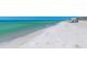 Beautiful beach featuring clear turquoise water, white sand, and ample space for relaxation at 3260 Bayou Rd, Longboat Key, FL 34228