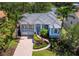 Beautiful home featuring a tile roof, lush landscaping, and a brick paved driveway at 3260 Bayou Rd, Longboat Key, FL 34228