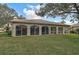 House back view, showcasing a large screened patio and grassy backyard at 3379 Hadfield Greene # 56, Sarasota, FL 34235