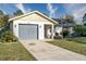 Single-story house with gray garage door and well-manicured lawn at 4532 N Shade Ave, Sarasota, FL 34234
