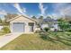 Cute one-story house with gray garage door and nicely landscaped lawn at 4532 N Shade Ave, Sarasota, FL 34234