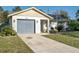 Single story home with gray garage door and landscaped yard at 4532 N Shade Ave, Sarasota, FL 34234