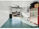 Bright garage with light teal floor, storage cabinets, and ladder at 4532 N Shade Ave, Sarasota, FL 34234