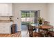 Kitchen with white cabinets, granite countertops, and access to backyard at 4532 N Shade Ave, Sarasota, FL 34234