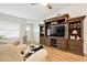 Living room boasts hardwood floors and a large entertainment center at 4532 N Shade Ave, Sarasota, FL 34234