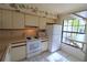 Kitchen features white appliances and a large window at 4713 Winslow Beacon # 5, Sarasota, FL 34235