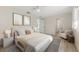 Bright bedroom with light wood floors, soft bedding, and decorative artwork at 5164 Windward Ave, Sarasota, FL 34242