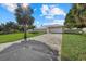 Charming single story home with lush landscaping, green lawn, and a concrete driveway at 5164 Windward Ave, Sarasota, FL 34242