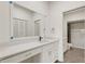 Modern bathroom with white vanity, quartz countertops and tile flooring at 5436 Hampstead Heath # 25, Sarasota, FL 34235
