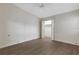 Clean and bright bedroom with ceiling fan, grey floors, and walk-in closet with louvered door at 5436 Hampstead Heath # 25, Sarasota, FL 34235