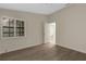 Clean and bright bedroom with ceiling fan, window, grey floors, and door to the ensuite bathroom at 5436 Hampstead Heath # 25, Sarasota, FL 34235