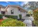 Well-maintained home exterior with lush landscaping and a view of the two-car garage at 5436 Hampstead Heath # 25, Sarasota, FL 34235