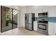 Kitchen showcasing stainless steel appliances, stylish backsplash, and sliding glass door at 5436 Hampstead Heath # 25, Sarasota, FL 34235
