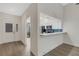 Updated kitchen featuring white cabinets, stainless steel appliances, and wood floors at 5436 Hampstead Heath # 25, Sarasota, FL 34235