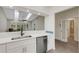 Kitchen featuring stainless steel dishwasher and a view into the living room at 5436 Hampstead Heath # 25, Sarasota, FL 34235