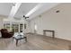 Bright living room featuring skylights, ceiling fan, tile flooring and multiple windows at 5436 Hampstead Heath # 25, Sarasota, FL 34235