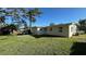 Backyard view of house with grassy area and patio at 5938 S Lockwood Ridge Rd, Sarasota, FL 34231