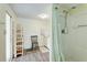 Bright bathroom with a stand-up shower, practical shelving, and a clean, minimalist design at 604 49Th Avenue W Dr, Bradenton, FL 34207