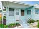 Quaint front porch with white door and flowering plants at 604 49Th Avenue W Dr, Bradenton, FL 34207