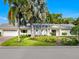 Attractive single-story home with palm trees and well-manicured landscaping at 606 Owl Way, Sarasota, FL 34236