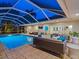 Night view of a refreshing pool with a covered patio and seating at 606 Owl Way, Sarasota, FL 34236