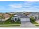 Modern house with gray roof, white garage doors, and a landscaped yard at 7228 Ryedale Ct, Sarasota, FL 34241