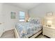 Bedroom with coastal bedding and a white dresser at 9272 Ballaster Pointe Loop, Parrish, FL 34219