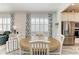 Round dining table with white chairs in bright dining area next to kitchen at 9272 Ballaster Pointe Loop, Parrish, FL 34219