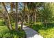 Paved pathway winds through lush botanical gardens at 988 Blvd Of The Arts # 1016, Sarasota, FL 34236