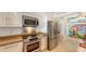 Modern kitchen with stainless steel appliances and granite countertops at 988 Blvd Of The Arts # 1016, Sarasota, FL 34236