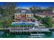 Aerial view of an estate with a pool, dock, and beautifully landscaped grounds, near the water at 1541 Bay Point Dr, Sarasota, FL 34236