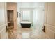 Sleek bathroom featuring a modern freestanding tub, glass shower, and stylish herringbone tile at 1541 Bay Point Dr, Sarasota, FL 34236