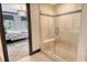 Walk in shower features glass door, built-in seat, and tiled accent strip at 1541 Bay Point Dr, Sarasota, FL 34236