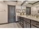 Elegant bathroom with dual sinks, gray cabinets, quartz countertop, and framed mirror at 1541 Bay Point Dr, Sarasota, FL 34236