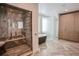 Luxurious bathroom featuring a glass shower, soaking tub, wood cabinets, and herringbone tile at 1541 Bay Point Dr, Sarasota, FL 34236