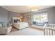 Comfortable bedroom featuring a cozy window seat, white wicker bed, and soft blue accents at 1541 Bay Point Dr, Sarasota, FL 34236