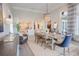 Spacious dining room featuring a large table, chandelier, and views into the kitchen at 1541 Bay Point Dr, Sarasota, FL 34236
