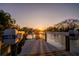Picture perfect sunset reflecting over water with custom docks and davits at 1541 Bay Point Dr, Sarasota, FL 34236